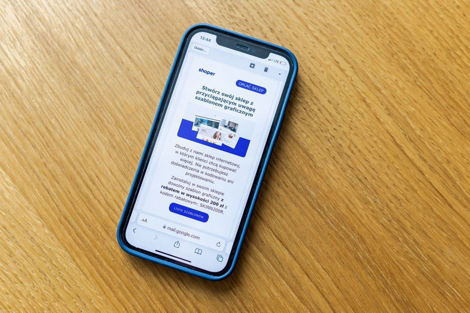 แคมเปญ 11.11 — Close-up of a smartphone on a wooden table showing an online shopping webpage.