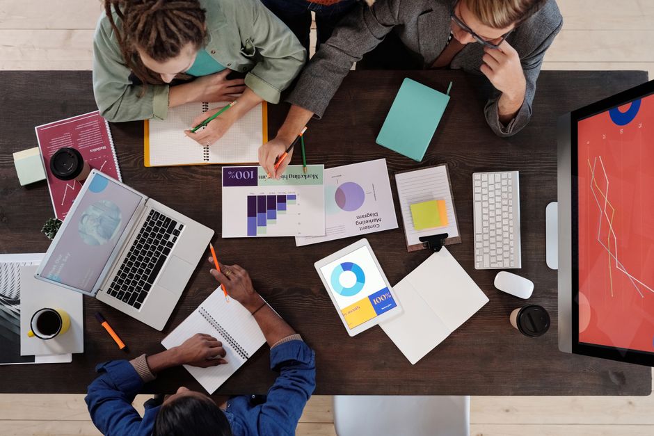 lookalike audience คือ — Overhead view of a diverse team collaborating on a project in a modern office setting.