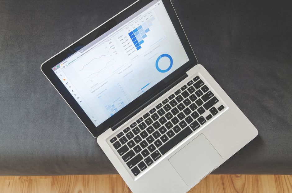 utm parameter — Overhead view of a laptop showing data visualizations and charts on its screen.