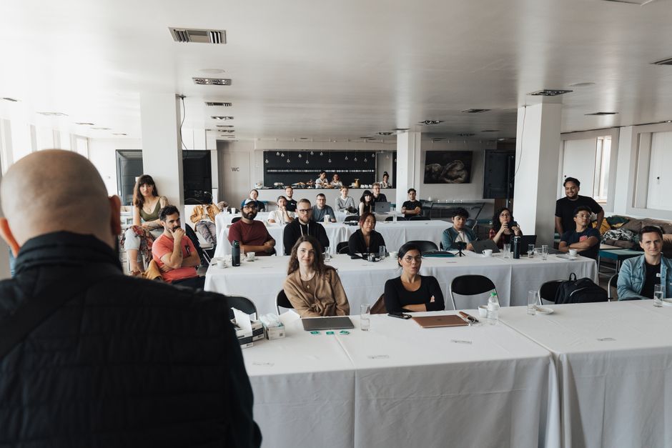 thought leadership b2b — A diverse group of business professionals attending a presentation in a modern conference room.