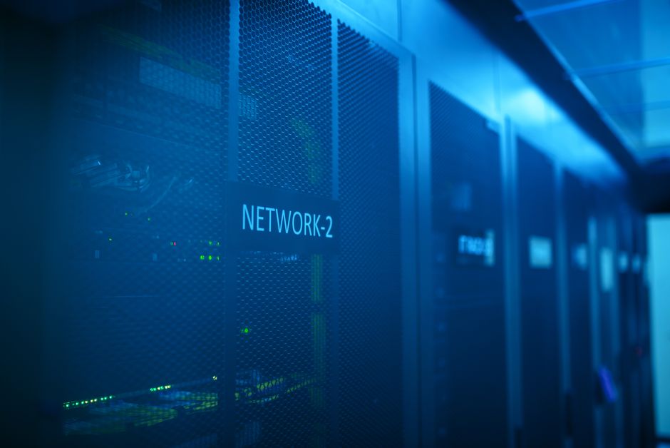 data clean room — A modern server room featuring network equipment with blue illumination. Ideal for technology themes.