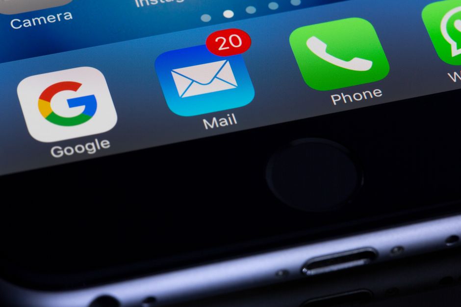 sms marketing — A close-up photo of a smartphone displaying popular apps like Google and Mail.