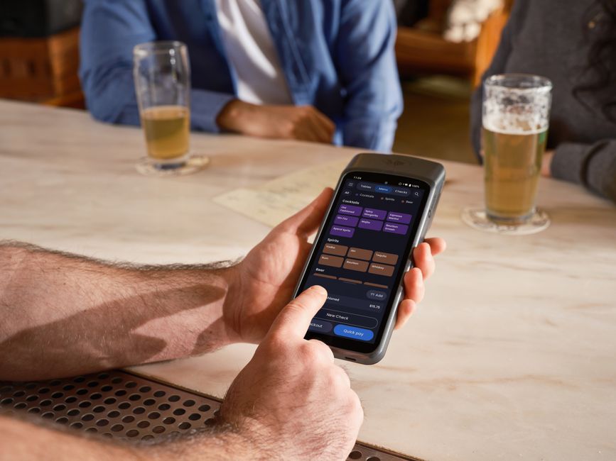 loyalty program ไทย setup — Handheld POS device used in a restaurant for efficient mobile ordering and payment processin