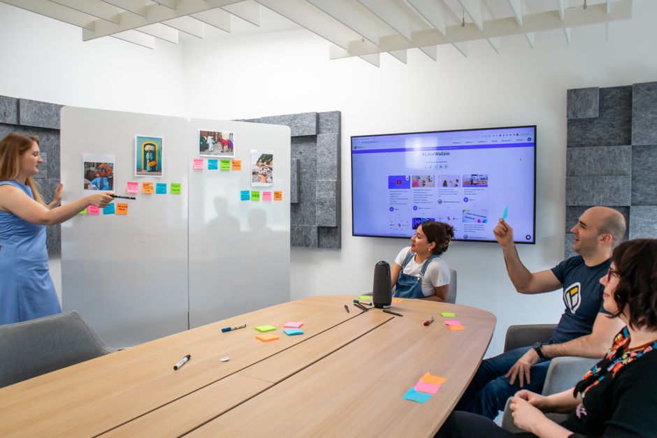 value proposition คือ — A group of coworkers engaged in a creative brainstorming session with colorful Post-it notes and