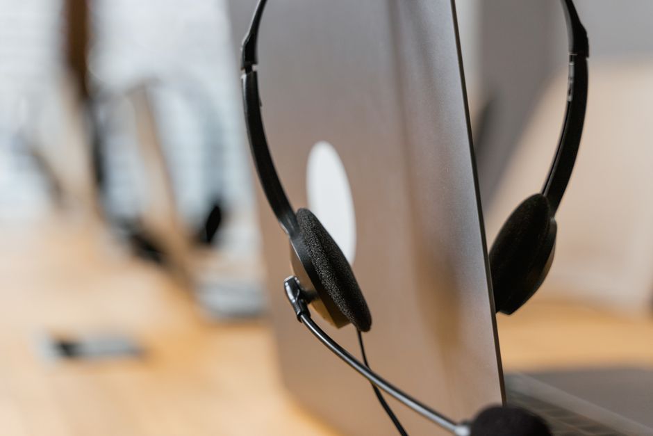 ai chatbot marketing — Close-up of a headset resting on a laptop, symbolizing efficient work environment technology.