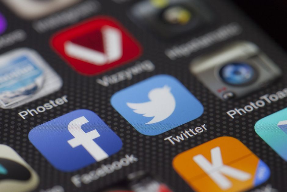 gamification marketing — A detailed close-up of social media icons on a smartphone screen, including Facebook and Twitte